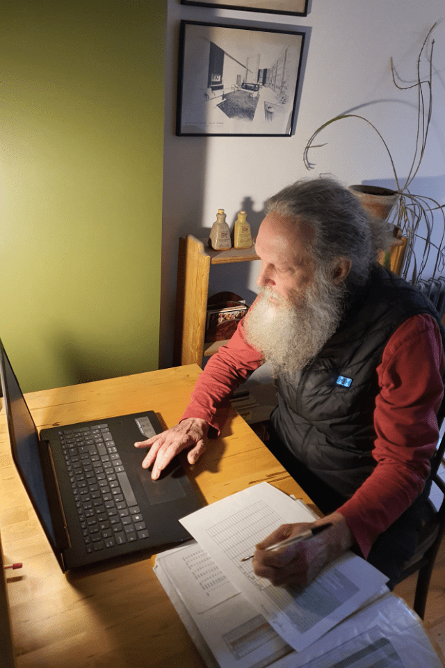 Dr. Ross Cooper writing at his computer